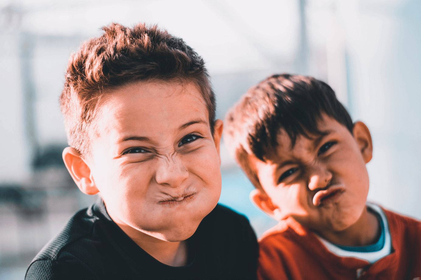 two young boys pulling silly faces