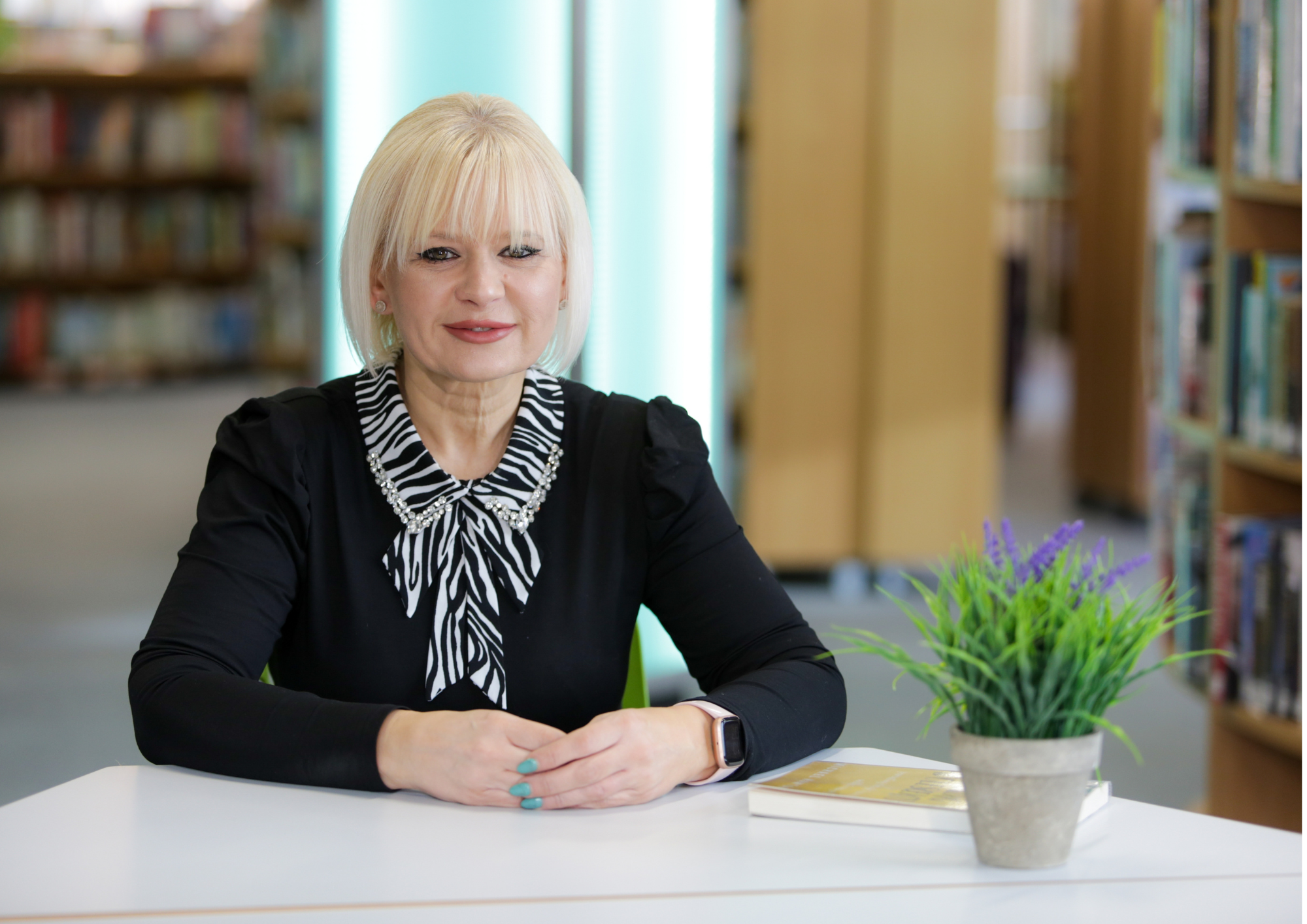 Foster carer Caroline wearing black cardigan, black and white blouse.