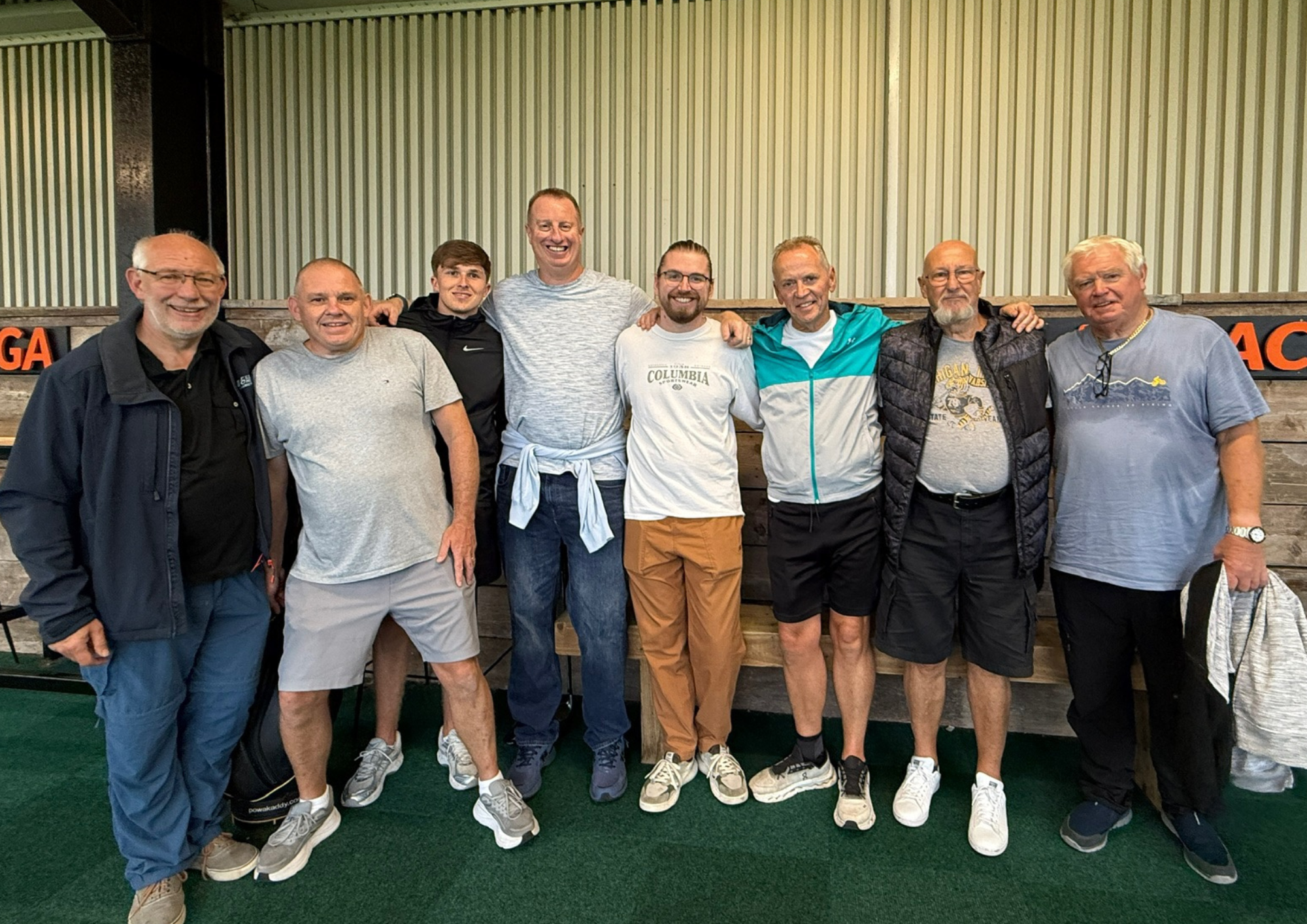 Male Foster Carers smiling together at the driving range